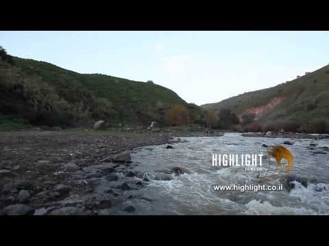LN 035 Israel stock footage library: Low angle of Jordan River bustling water in winter